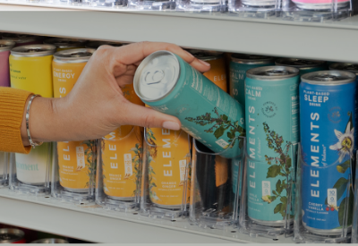 A woman's hand getting a drink can from a Visi-Fast shelf